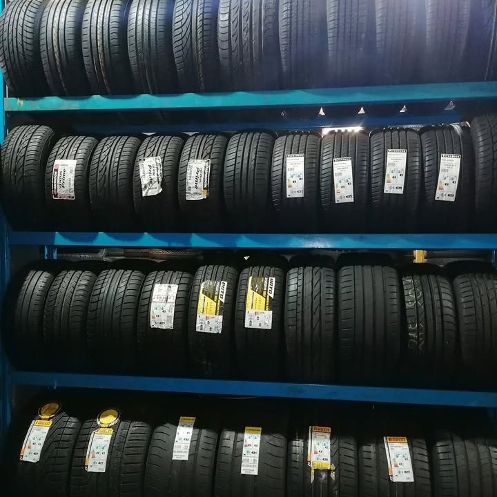 Rows of new tyres on blue racking at ZH Tyres
